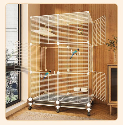 Large black metal bird cage with two columns and three levels, including perches, platforms, food bowls, and a pull-out tray. Two parrots are visible inside. - Image 11