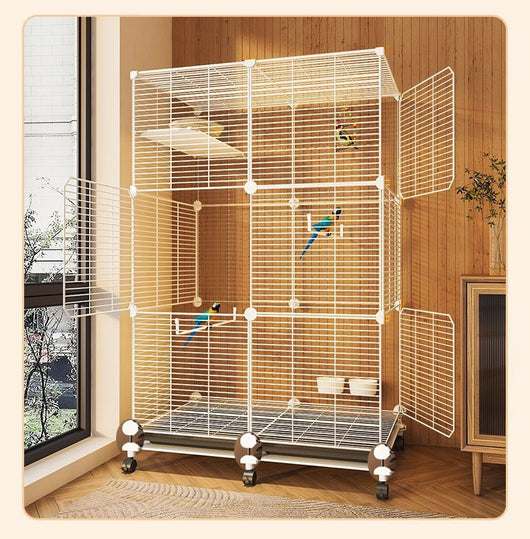 Large black metal bird cage with two columns and three levels, including perches, platforms, food bowls, and a pull-out tray. Two parrots are visible inside. - Image 11