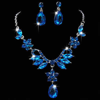 Purple rhinestone statement necklace with silver-tone setting, featuring floral and leaf motifs and a teardrop pendant. - Image 3