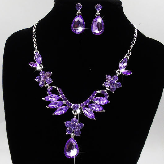 Purple rhinestone statement necklace with silver-tone setting, featuring floral and leaf motifs and a teardrop pendant. - Image 4