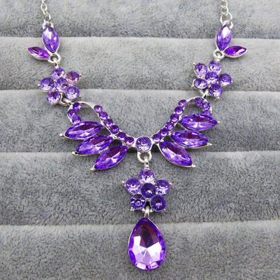 Purple rhinestone statement necklace with silver-tone setting, featuring floral and leaf motifs and a teardrop pendant. - Image 5