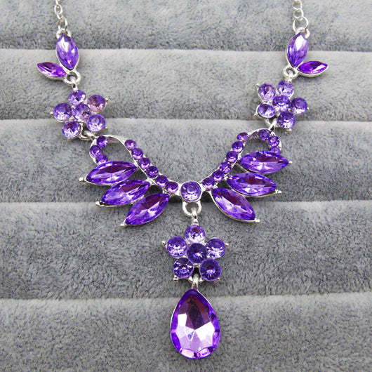 Purple rhinestone statement necklace with silver-tone setting, featuring floral and leaf motifs and a teardrop pendant. - Image 5