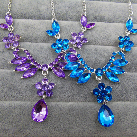 Purple rhinestone statement necklace with silver-tone setting, featuring floral and leaf motifs and a teardrop pendant. - Image 2