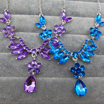 Purple rhinestone statement necklace with silver-tone setting, featuring floral and leaf motifs and a teardrop pendant. - Image 2