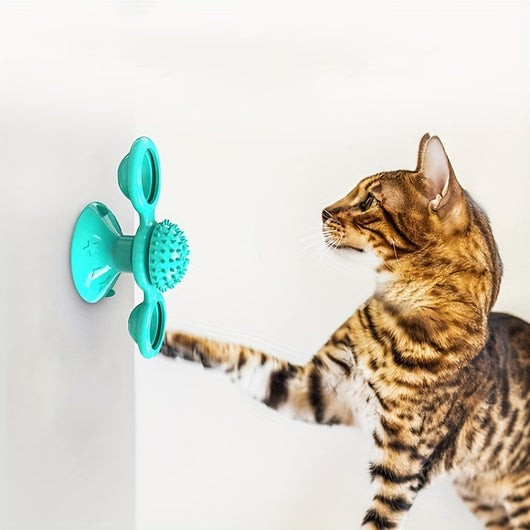 Gray tabby cat playing with a teal windmill cat toy featuring a suction cup base, textured ball, and colorful spinning paddles. - Image 6