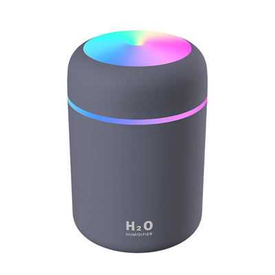 Dark gray ultrasonic aromatherapy essential oil diffuser with a colorful LED light band and rainbow top light. - Image 9
