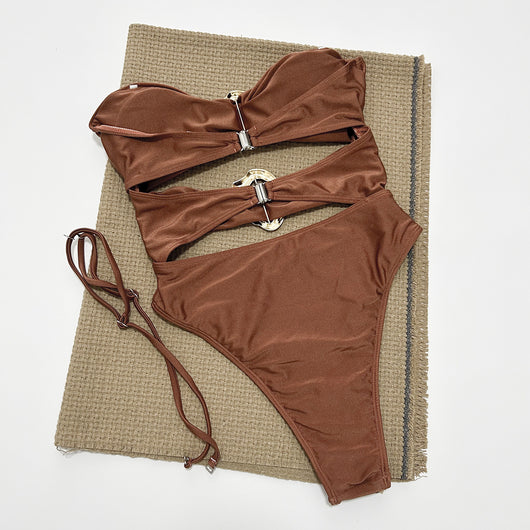 Red one-piece swimsuit with a strapless bandeau top, midriff cut-outs, and two gold-tone buckle details. Features a high-cut bottom. - Image 13