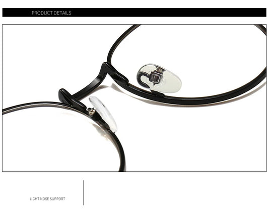 Black round anti-blue light glasses with clear lenses showing a blue reflection, resting on a gray textured surface. - Image 13