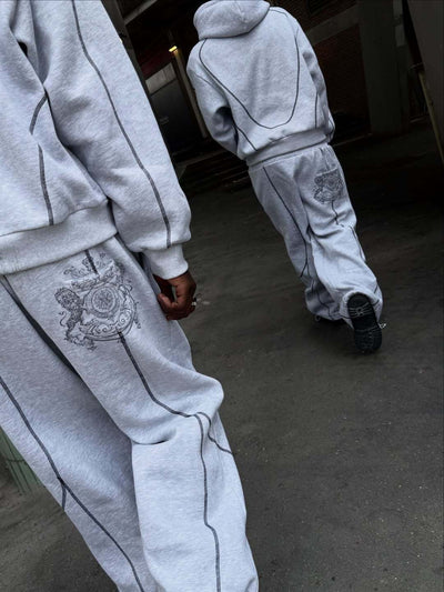 Light gray hooded tracksuit with dark gray contrast stitching, featuring a full-zip hoodie and matching loose sweatpants. - Image 11