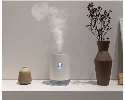 White cylindrical humidifier with a transparent base, digital display, and 1000ml capacity indicator. - Image 2