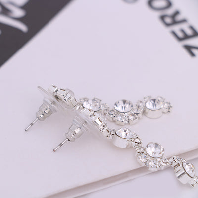 Sparkling silver-tone necklace and stud earrings set with clear round rhinestones, displayed on a black jewelry bust. - Image 5