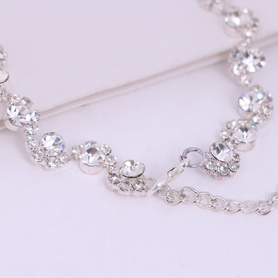 Sparkling silver-tone necklace and stud earrings set with clear round rhinestones, displayed on a black jewelry bust. - Image 4