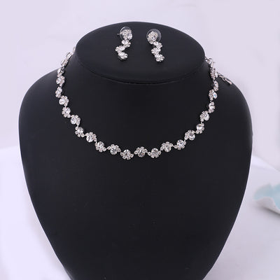 Sparkling silver-tone necklace and stud earrings set with clear round rhinestones, displayed on a black jewelry bust. - Image 6