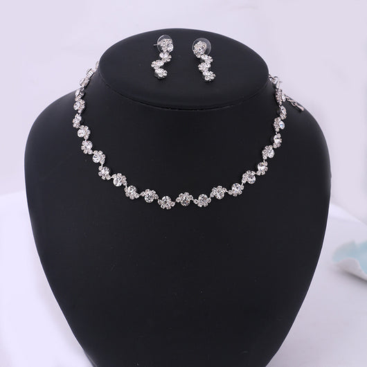 Sparkling silver-tone necklace and stud earrings set with clear round rhinestones, displayed on a black jewelry bust. - Image 6