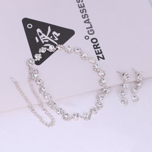 Sparkling silver-tone necklace and stud earrings set with clear round rhinestones, displayed on a black jewelry bust. - Image 3