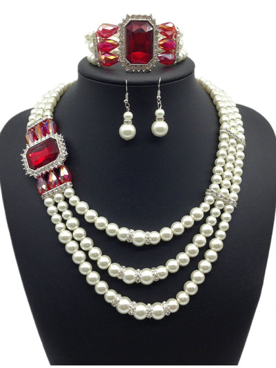 Three-piece jewelry set with multi-strand pearl necklace, blue gemstone pendant, matching pearl drop earrings, and pearl bracelet.