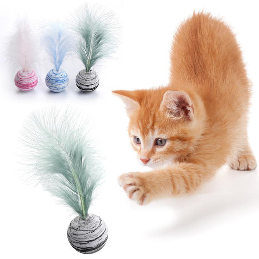 White foam cat toy ball with blue swirl patterns and a light blue feather on top, for feline play.