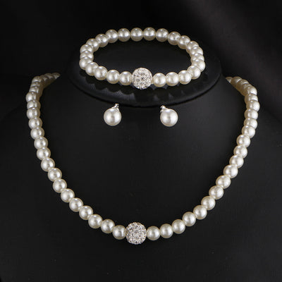 White pearl necklace, bracelet, and stud earrings set with pave crystal ball accents, displayed on a black stand. - Image 4