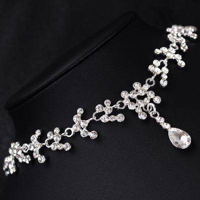 Silver-tone bridal necklace and drop earrings set with clear rhinestones and teardrop faux diamonds. - Image 2