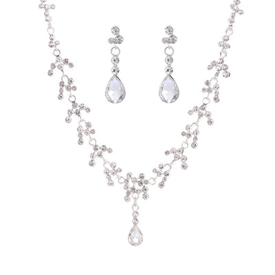 Silver-tone bridal necklace and drop earrings set with clear rhinestones and teardrop faux diamonds. - Image 6