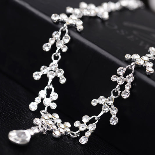 Silver-tone bridal necklace and drop earrings set with clear rhinestones and teardrop faux diamonds.