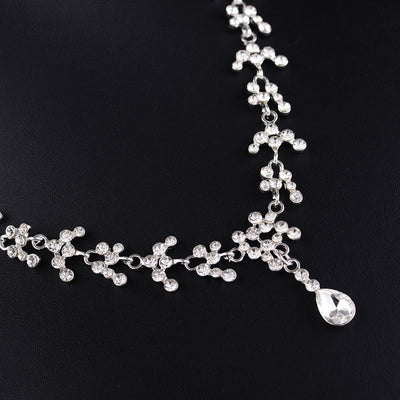 Silver-tone bridal necklace and drop earrings set with clear rhinestones and teardrop faux diamonds. - Image 3