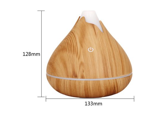 Teardrop-shaped aromatherapy humidifier with light wood grain finish, emitting mist and glowing with purple LED light. - Image 9
