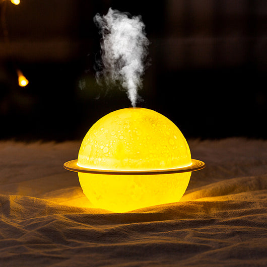 White moon-shaped humidifier with a textured surface resembling craters and a thin ring around its middle. - Image 6