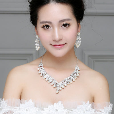 Silver-tone necklace and matching chandelier earrings set with clear rhinestones and white faux pearls.