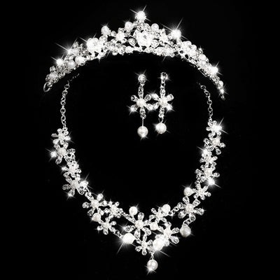 Bridal jewelry set with a silver-tone necklace and matching drop earrings, featuring crystal flowers and faux pearls.