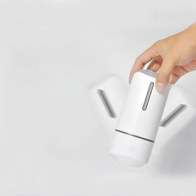 Pink columnar mini car humidifier with a power button and a clear water level indicator on a white background. - Image 10