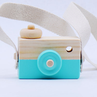 Two-tone wooden toy camera in natural wood and light blue with a cream fabric strap, for babies and kids. - Image 5