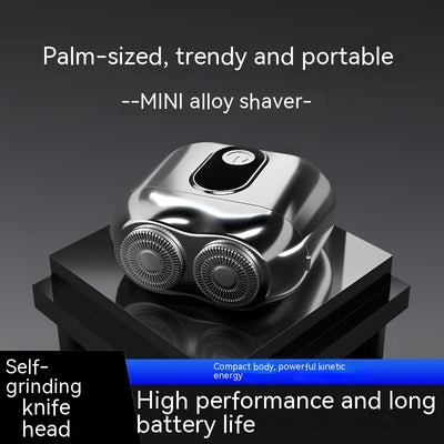 Silver mini electric shaver with a double-headed rotary design and a black power button on top.