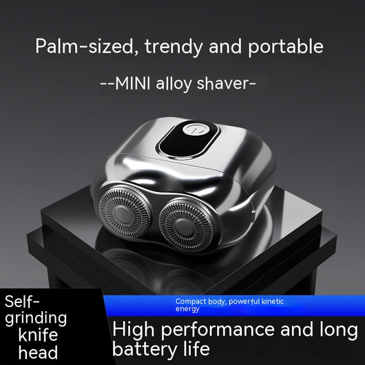 Silver mini electric shaver with a double-headed rotary design and a black power button on top.