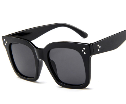 Matte black square-frame sunglasses with dark gray lenses and three white dot accents on each temple.