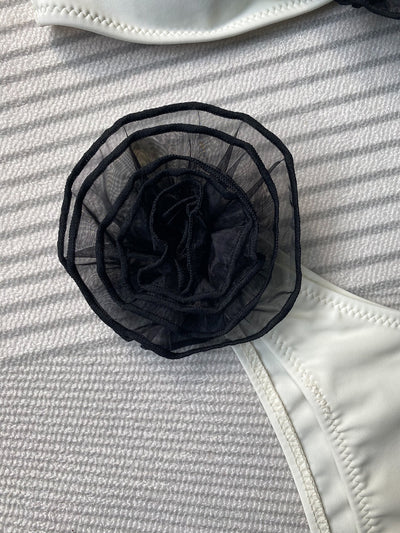 Black tube top bikini with white three-dimensional flower embellishments, worn by a woman partially submerged in water. - Image 20