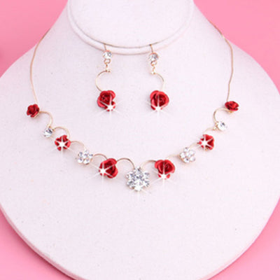 Red rose and clear crystal necklace and matching earrings set on a white jewelry bust, with a pink background. - Image 6