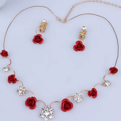 Red rose and clear crystal necklace and matching earrings set on a white jewelry bust, with a pink background. - Image 2