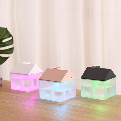 Two house-shaped USB humidifiers, one dark gray and one pink, with clear bases showing H₂O text. - Image 9