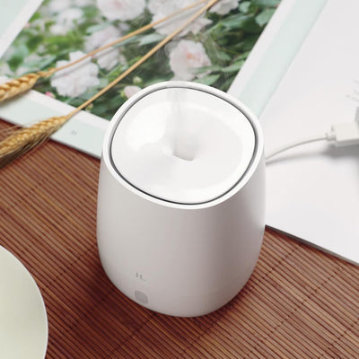 White mini aromatherapy machine with a minimalist design, featuring a top mist outlet and a single control button. - Image 4