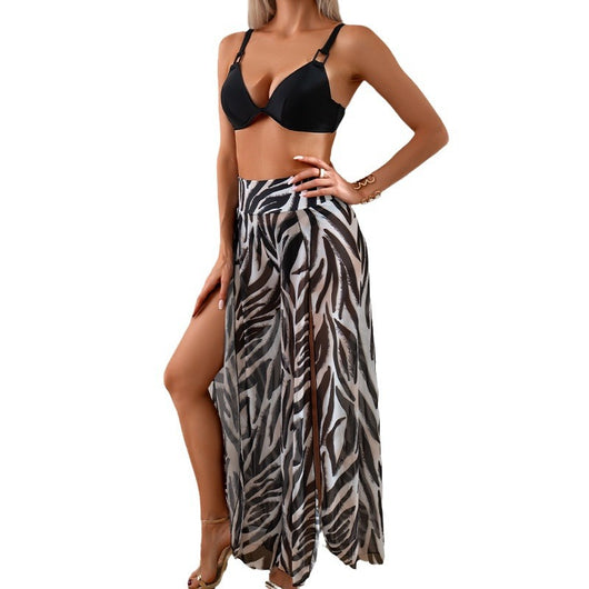 Women's pink, black, and white abstract striped bikini with a push-up top and strappy high-cut bottoms on a beach. - Image 5