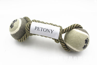 Braided rope dog chew toy with two tennis balls featuring paw prints, shown with a dog holding a similar toy. - Image 4