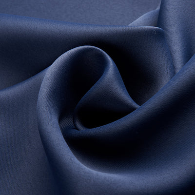 Dark blue blackout curtains with silver grommet tops hanging on a rod in a modern bedroom setting. - Image 6