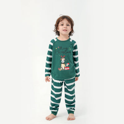 Woman in a Christmas pajama set with a white top, green sleeves, dinosaur graphic, and green fair isle pants. - Image 7