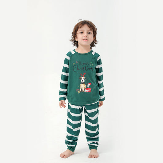 Woman in a Christmas pajama set with a white top, green sleeves, dinosaur graphic, and green fair isle pants. - Image 7