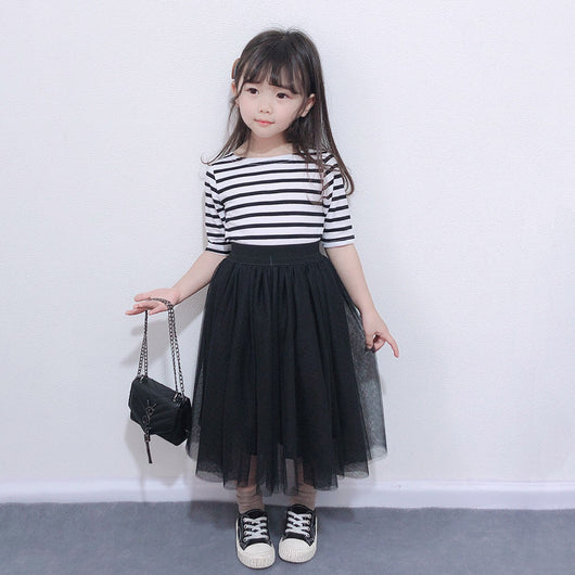 Children's two-piece dress with a black and white striped short-sleeve top and a black gathered tulle skirt.