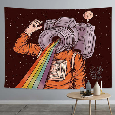 Abstract tapestry featuring an astronaut with a camera head emitting a rainbow, set against a dark starry space background.