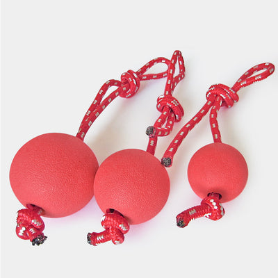 Red solid rubber elastic ball with a red and white braided rope, designed as a durable dog chew and training toy. - Image 4