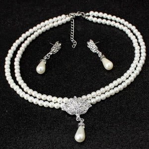 Two-strand faux pearl necklace with a rhinestone lotus pendant and matching teardrop pearl dangle earrings. - Image 3