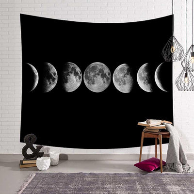 Black tapestry featuring a horizontal display of the moon's phases, from crescent to full and back, against a white brick wall. - Image 2